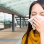 Woman blowing her nose in public
