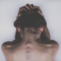 Woman holding head in hands