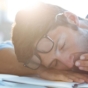 Man resting and yawning on his desk