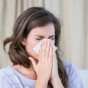 Woman blowing nose
