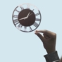 Man holding pill up to clock