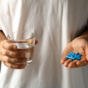 Blue viagra pills in man's hand