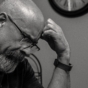 Concerned man with head in hands