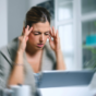 Woman experiencing dizziness at her desk